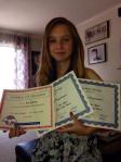 Ava with her elementary school diploma, her "Citizenship" award and her "Work Habits" award